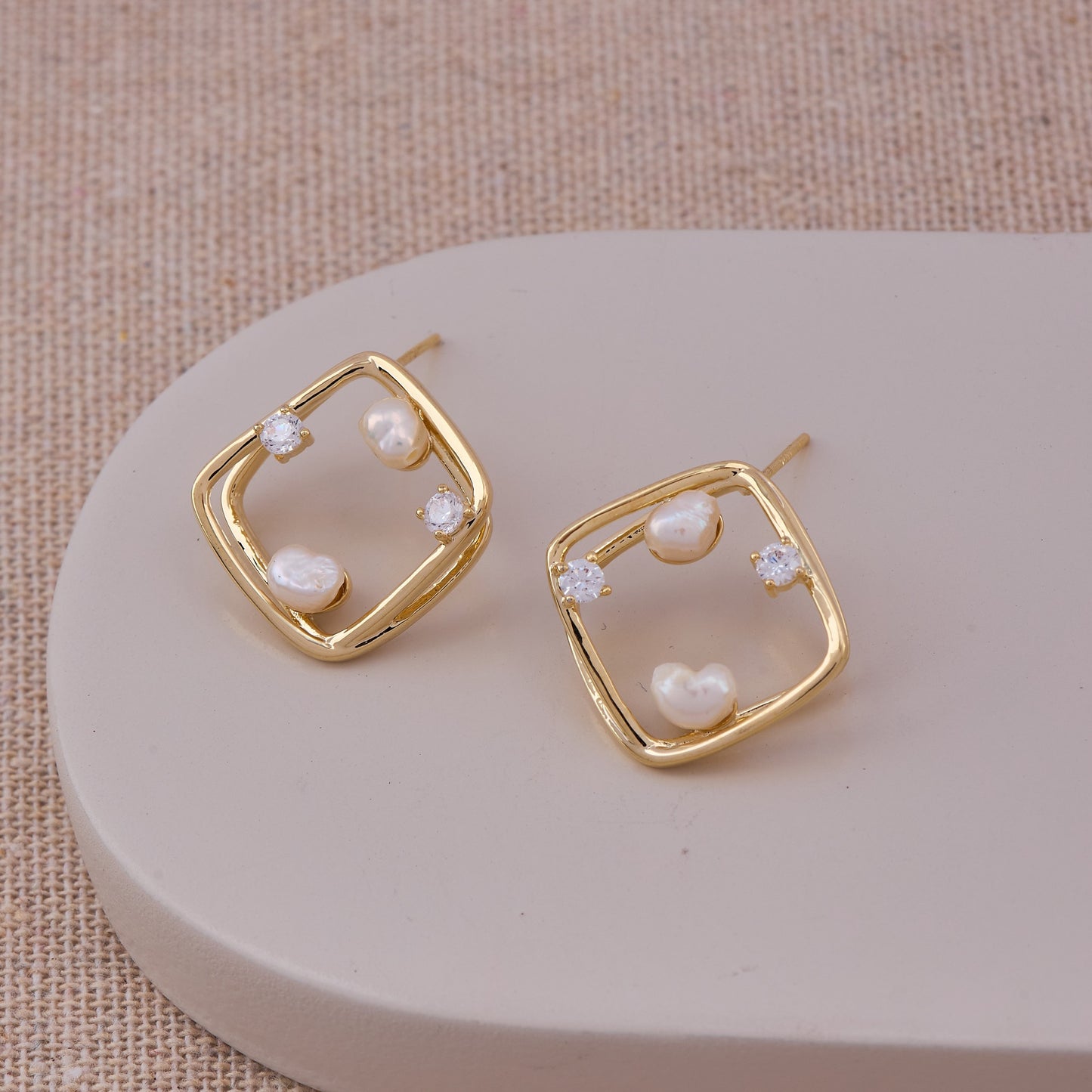 Gold & Pearl Earrings on Warm Tan