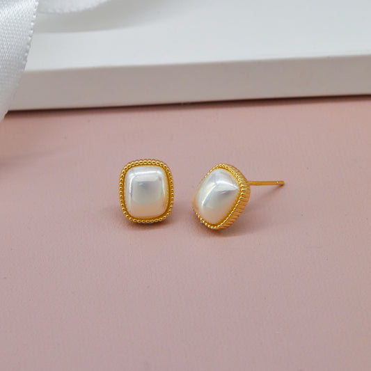 Elegant Earrings Intricate Craftsmanship on Pink Display