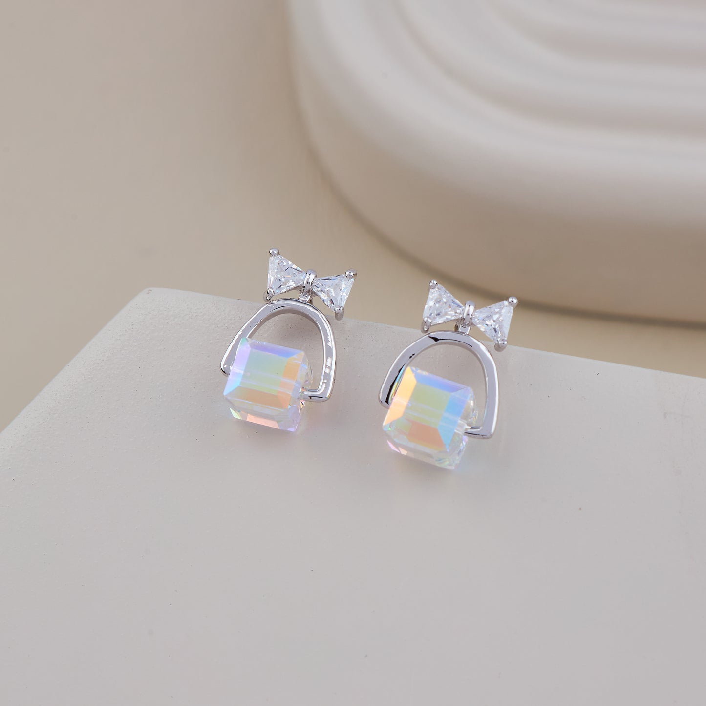 Silver Bow Earrings with Iridescent Cube Drop
