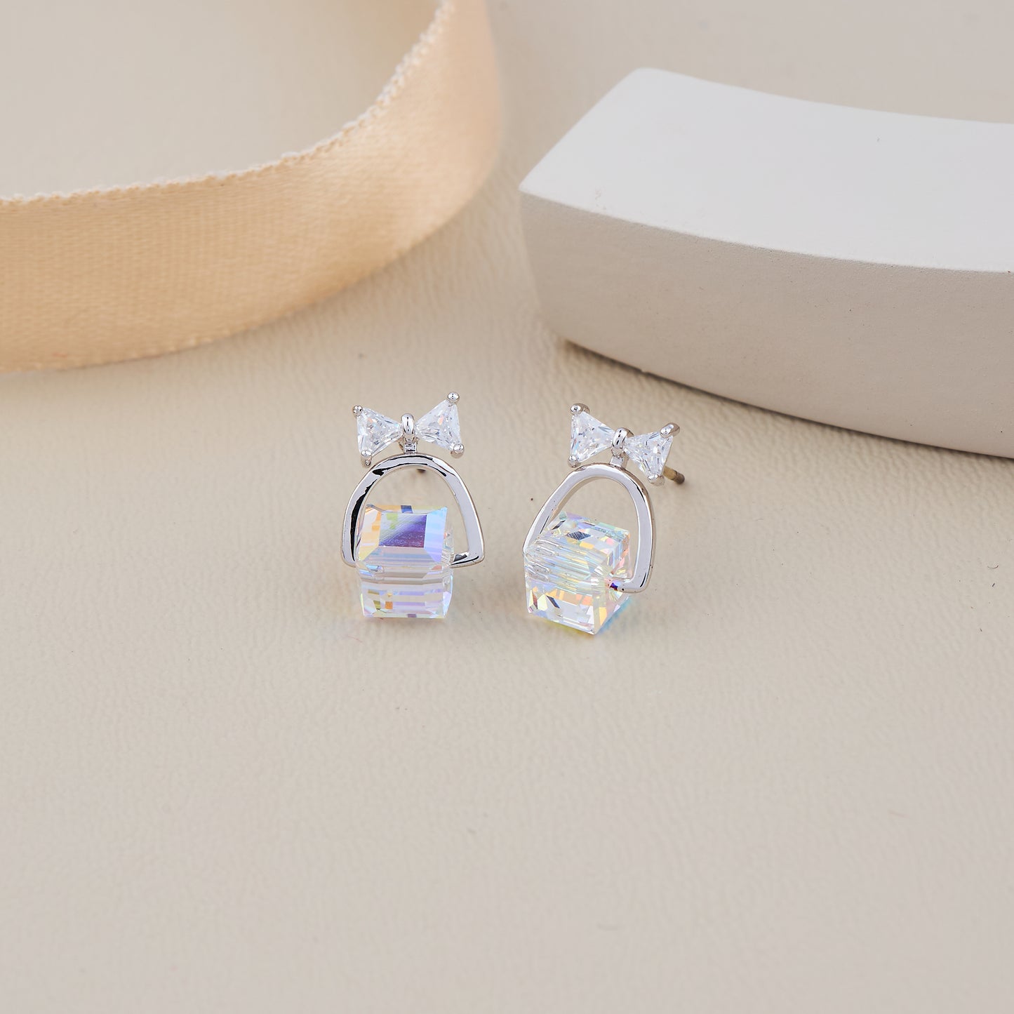 Silver Bow Earrings with Iridescent Cube Drop