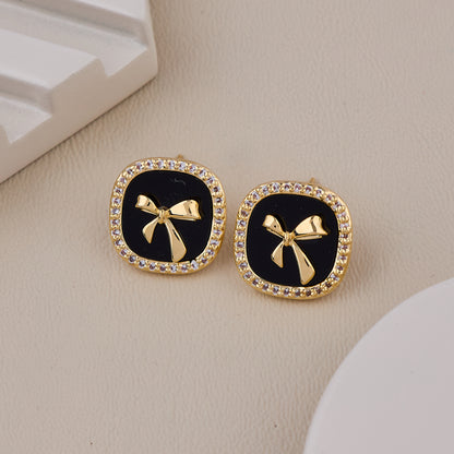 Chic Black Enamel Stud Earrings with Gold Bow Motif