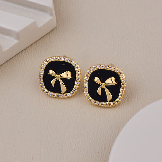 Chic Black Enamel Stud Earrings with Gold Bow Motif