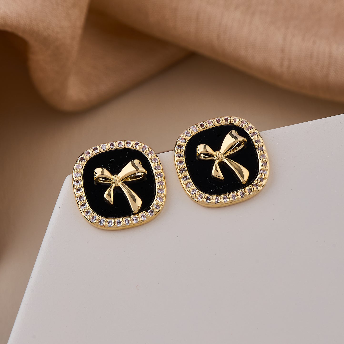 Chic Black Enamel Stud Earrings with Gold Bow Motif