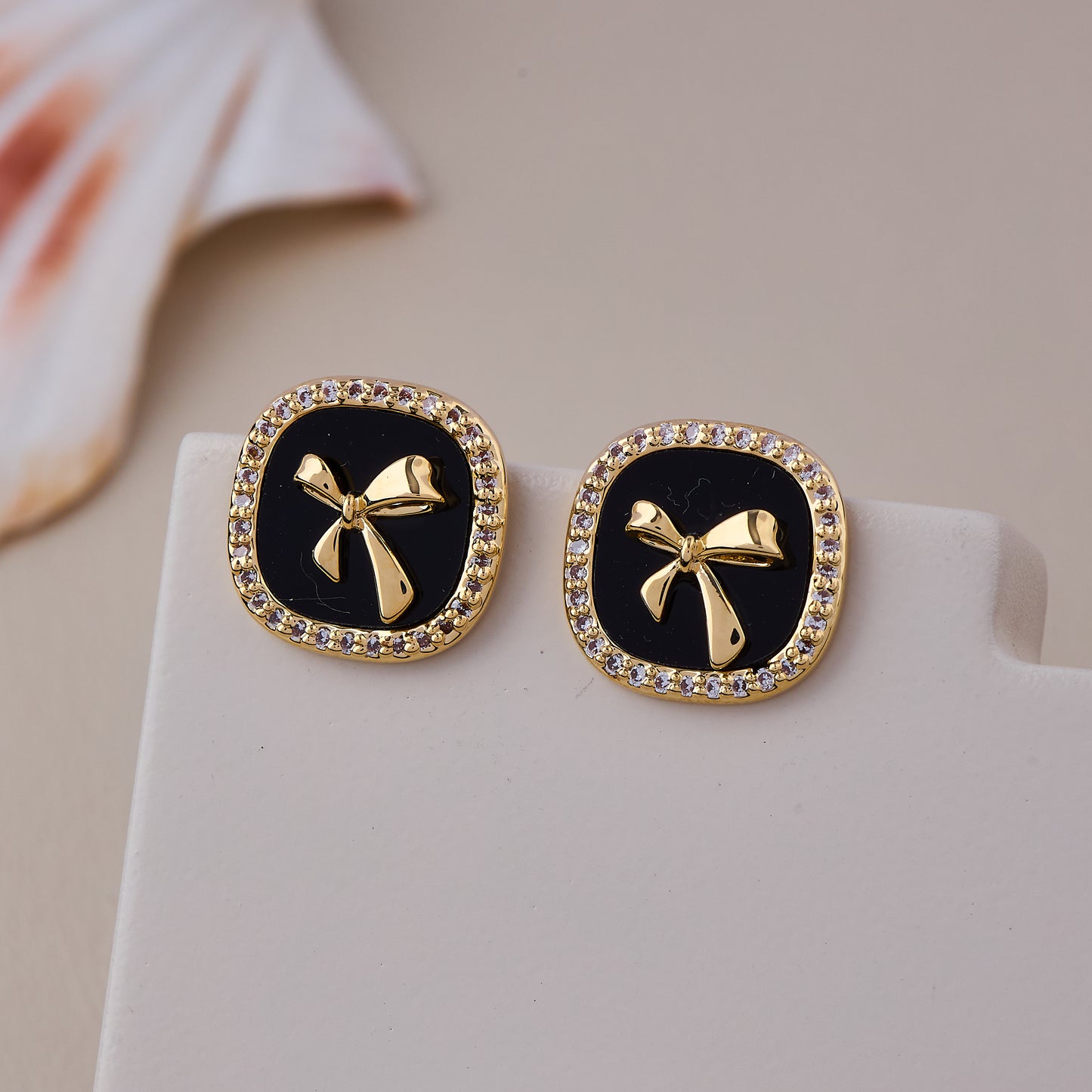 Chic Black Enamel Stud Earrings with Gold Bow Motif