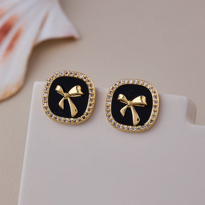 Chic Black Enamel Stud Earrings with Gold Bow Motif