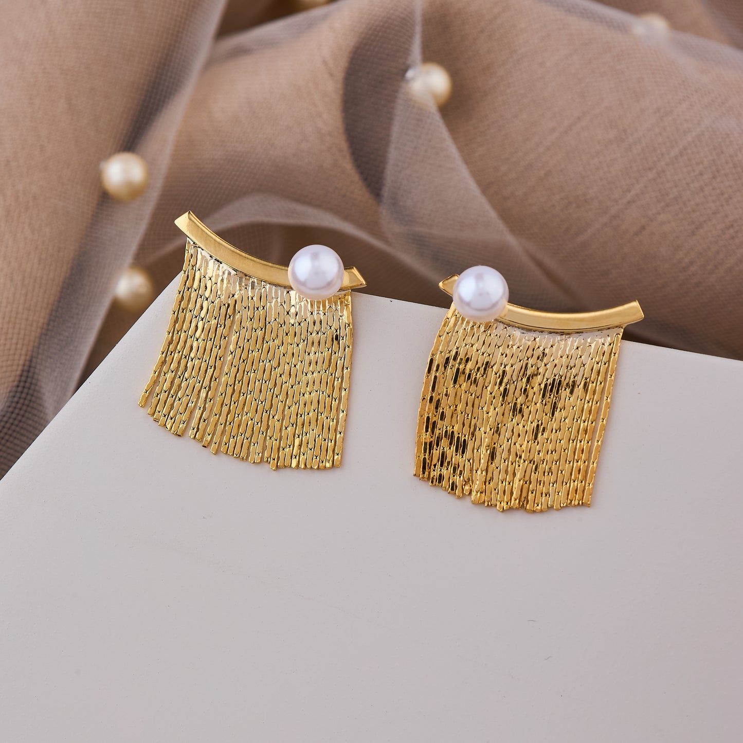 Golden fringe studs with pearl tops