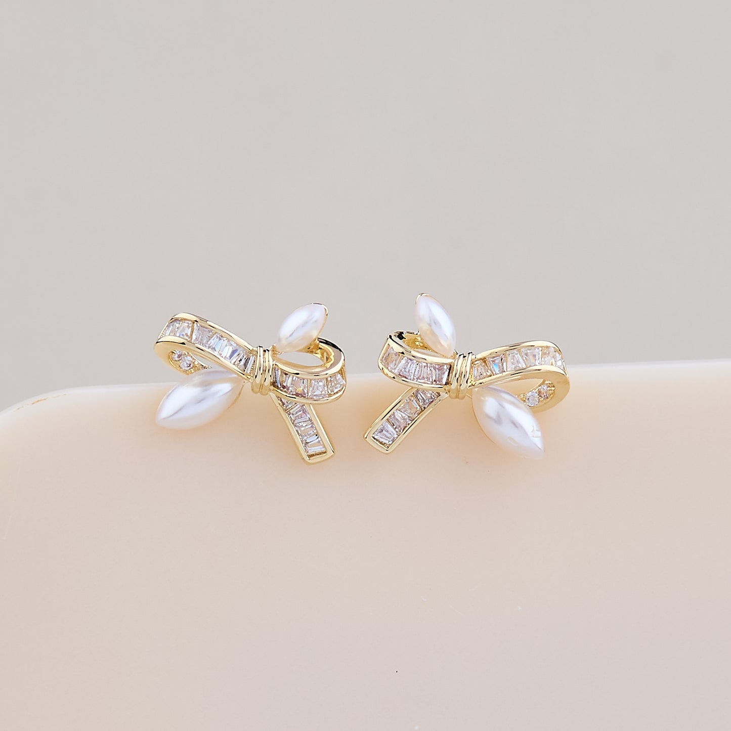 Elegant Pearl Bow Earrings with Crystal Detailing